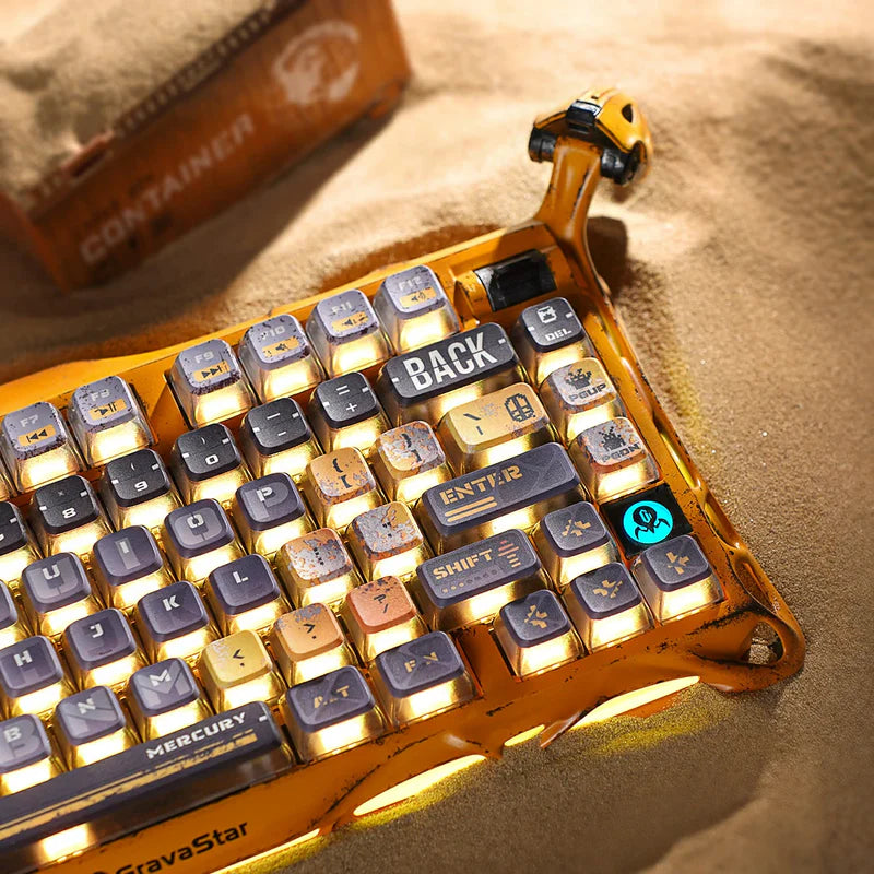 GravaStar Handcrafted Gaming Set in Battle-Worn Yellow, showcasing Mercury K1 Pro Special Edition and Mercury X Pro Special Edition gaming peripherals—each with a unique one-of-a-kind handcrafted aluminum alloy frame featuring Battle-Worn-inspired aesthetics. Includes a free GravaStar Keyboard Wrist Rest Pad (worth $12.95). Highlighted features: 75% compact layout for space-saving, dynamic RGB lighting (16.8M colors, 13 modes with South-facing key backlighting), premium build with 70M keystroke-rated switch